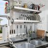 An organized kitchen rack with plates, knives, sauces, and utensils for efficient cooking and cleaning. Sleek stainless steel design suitable for home or commercial kitchens.