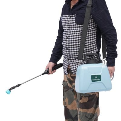 Alt text: Person holding a 5L blue disinfectant sprayer with a black nozzle, wearing camo pants and a checkered shirt, used for cleaning and sanitizing in medical or commercial settings.