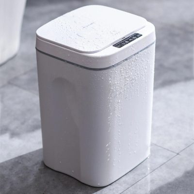 Modern white top-loading washing machine with water droplets, energy-efficient design, perfect for home laundry needs.