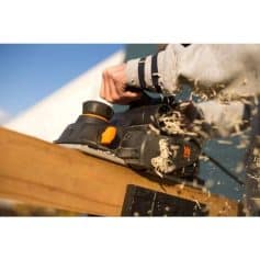 High-quality cordless handheld power saw in action, with wood shavings flying, showcasing precision and efficiency for carpentry and woodworking projects. Great for DIY and professional use.