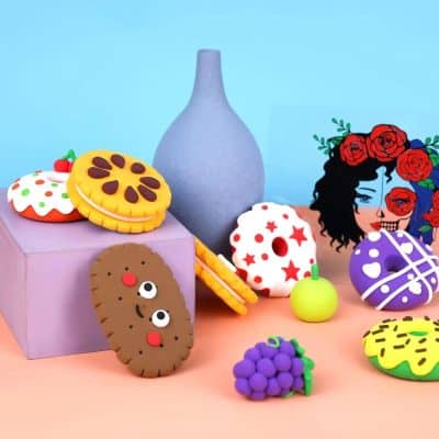 Delicate handcrafted clay cookies with playful designs, abstract art piece with roses, and elegant decorative items serve as creative eye-catching decor for opt.