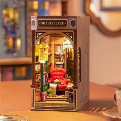 Charming miniature bookstore diorama featuring bookshelves, a cozy red armchair, and warm lighting, perfect for book lovers and literary enthusiasts interested in unique opt displays.