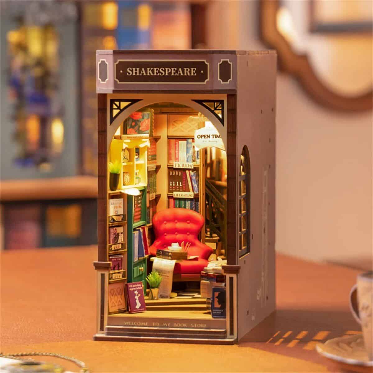Charming miniature bookstore diorama featuring bookshelves, a cozy red armchair, and warm lighting, perfect for book lovers and literary enthusiasts interested in unique opt displays.