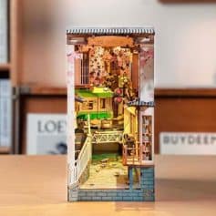 A miniature model of a cozy library set featuring bookshelves, reading nook, and decorative elements, perfect for home decor or gift.