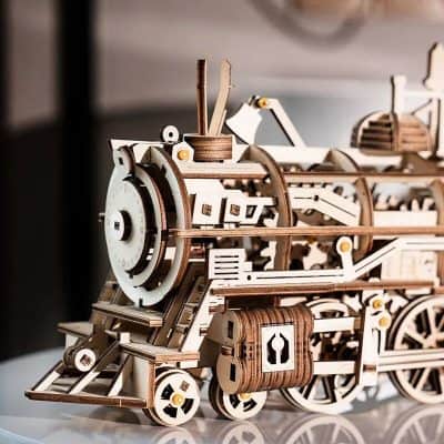 Detailed wooden model of a vintage steam engine for optical and educational display.