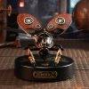 Intricate robotic butterfly with steampunk design featuring leather wings and metallic gears, sitting on a decorative base. Perfect for modern decor or tech-inspired art displays.