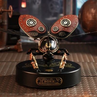 Intricate robotic butterfly with steampunk design featuring leather wings and metallic gears, sitting on a decorative base. Perfect for modern decor or tech-inspired art displays.