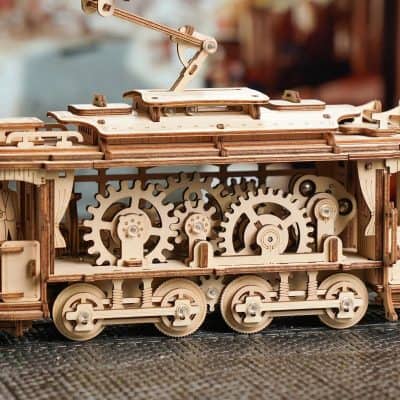 Detailed wooden mechanical train toy with gears and intricate craftsmanship, ideal for educational and decorative purposes, perfect for train enthusiasts.