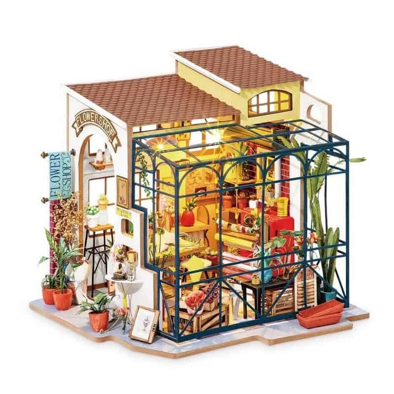 Detailed miniature flower shop with vibrant decor and tiny plants, perfect for home or office display, emphasizing flowers, gardening, and decorative craftsmanship.