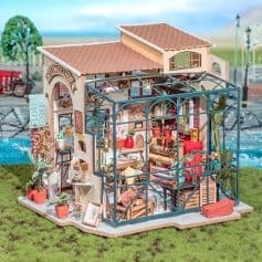 Detailed dollhouse with floral decor, glass greenhouse, and miniature furnishings for kids’ role-play and decorative collection.