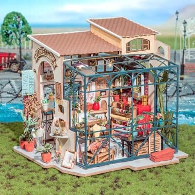 Detailed dollhouse with floral decor, glass greenhouse, and miniature furnishings for kids’ role-play and decorative collection.