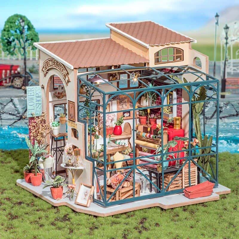 Detailed dollhouse with floral decor, glass greenhouse, and miniature furnishings for kids’ role-play and decorative collection.