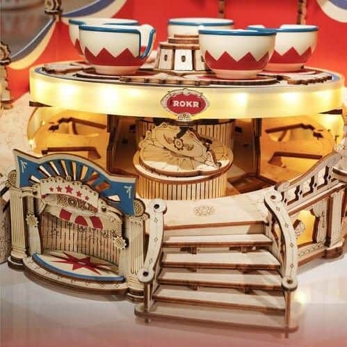 Colorful amusement park ride for kids, featuring a carousel with teacup seats and whimsical design elements, perfect for entertaining children at family-friendly events.