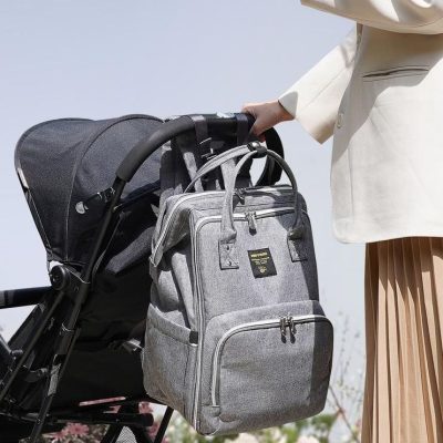 Versatile baby diaper bag with multiple compartments, perfect for moms on the go. Spacious and durable, ideal for storing baby essentials comfortably.