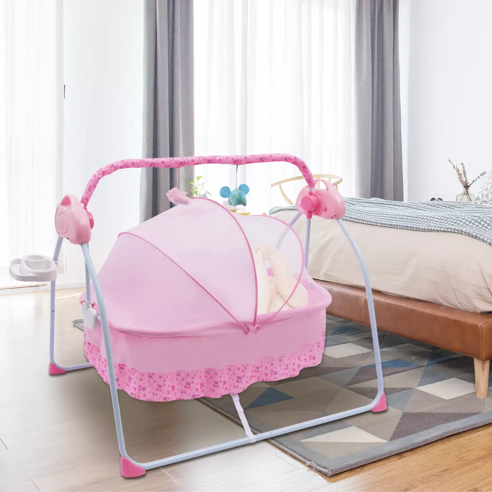 Light pink baby cradle with canopy, musical mobile, and adjustable frame for infant comfort and safety. Perfect for newborns, stylish, and easy to assemble.