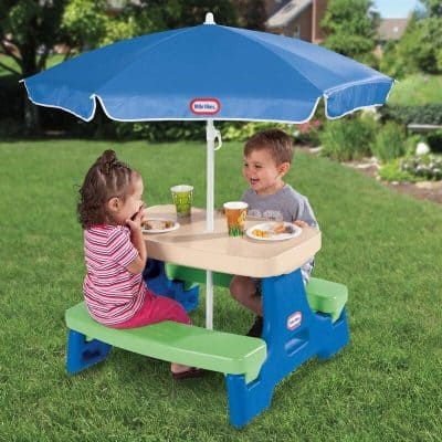 Colorful outdoor kids picnic table with an umbrella, perfect for children’s activities and meals in the yard. Durable plastic construction ensuring safety and easy cleaning for outdoor use.
