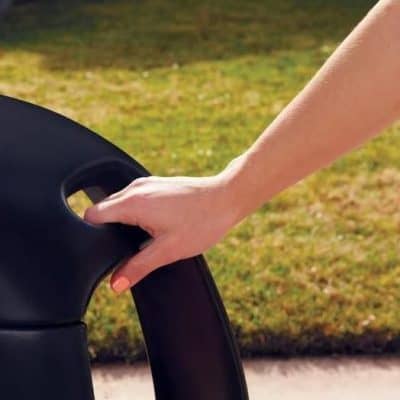 Hands holding a contact lens case outdoors, emphasizing comfortable and innovative vision correction solutions.