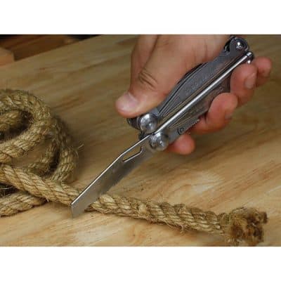 A compact multi-tool knife demonstrating rope cutting with a sturdy blade for versatile use, ideal for outdoor activities, camping, and rope work.