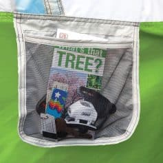 A convenient mesh travel organizer containing sunglasses, reading glasses, and a colorful card, perfect for storing and protecting eyewear and accessories on the go.