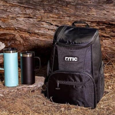 Durable black RTIC backpack with multiple compartments, ideal for travel and outdoor adventures, paired with stylish thermos bottles for beverages.