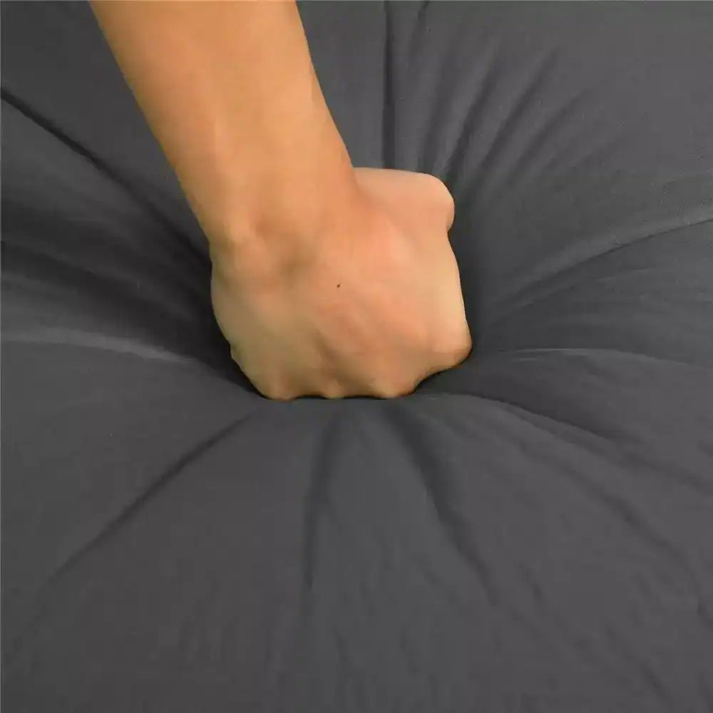 Comfortable black pillow with a hand pressing into it, showcasing softness and quality at Monalisa Medical. Perfect for comfortable seating or medical settings requiring ergonomic support.