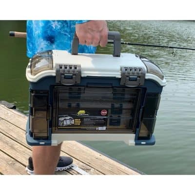 Waterproof fishing tackle box with secure latches, portable design for anglers, ideal for organizing and transporting fishing equipment by the water.