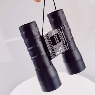 High-quality 12x32 binoculars for clear viewing, perfect for outdoor activities, sports events, and nature exploration. Compact, lightweight design with enhanced magnification and rugged durability.