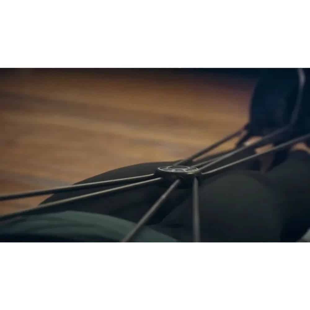 Close-up of bicycle wheel with black tire and spokes in a modern loop design, showcasing high-quality replacement bike parts from Monalisa Store for optimal cycling performance.