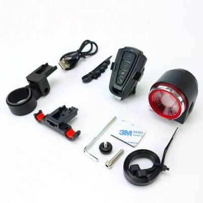 Key fob with remote controls, battery, mounting accessories, and USB charger for efficient vehicle or bike security.