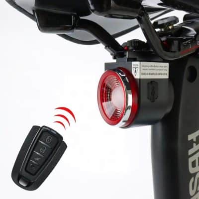 Battery-powered electric bike tail light with remote key fob for improved safety during night rides.