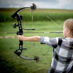 Child shooting with a compound bow outdoors, emphasizing children's archery gear, safety, and beginner-friendly options from Monalisa Store.