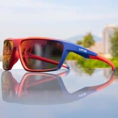 High-performance blue and red sports sunglasses with polarized lenses for UV protection, ideal for outdoor activities and sports enthusiasts.