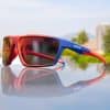 Vibrant red and blue sports sunglasses with mirrored lenses, perfect for outdoor activities, sports, riding, cycling, and running. Designed for comfort and style, enhancing your active lifestyle.