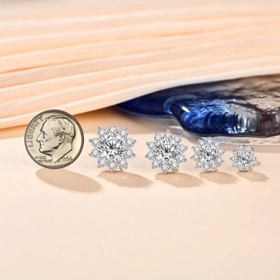 Stunning diamond snowflake-shaped earrings displayed with vintage coin for size comparison, perfect for jewelry lovers seeking luxurious and sparkling accessories at Monalisa Medical Store.