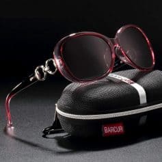 Stylish red tinted sunglasses for sun protection and fashion.