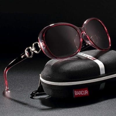 Stylish red tinted sunglasses for sun protection and fashion.