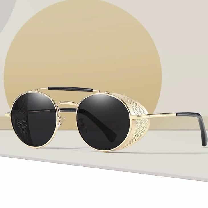 Luxury aviator sunglasses featuring gold frames, black tinted lenses, and sleek design, ideal for fashion-forward individuals and sun protection.