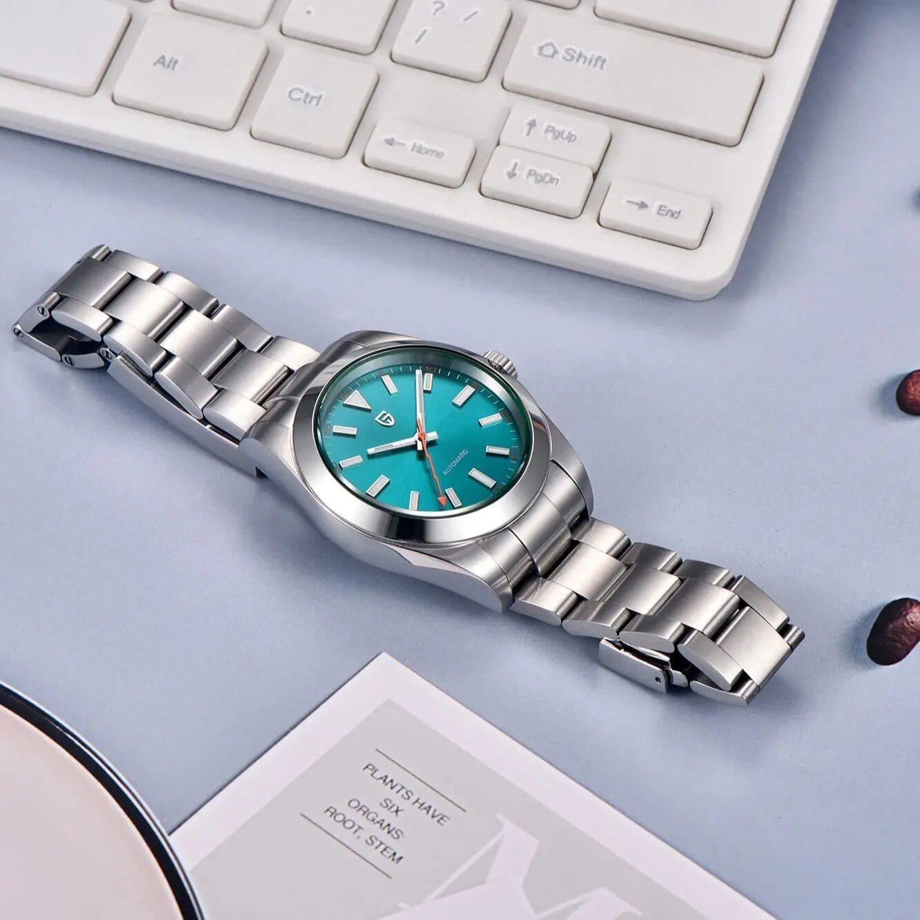 Stylish stainless steel wristwatch with a vibrant turquoise dial, perfect for fashion-forward individuals seeking quality eyewear and accessories at Monalisa Store.
