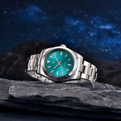 Stainless steel wristwatch with a vibrant turquoise dial, sleek design, and automatic movement, ideal for watch enthusiasts and fashion-forward individuals.