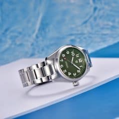 Elegant stainless steel men's watch on white surface with blue background, perfect for fashion and everyday use.