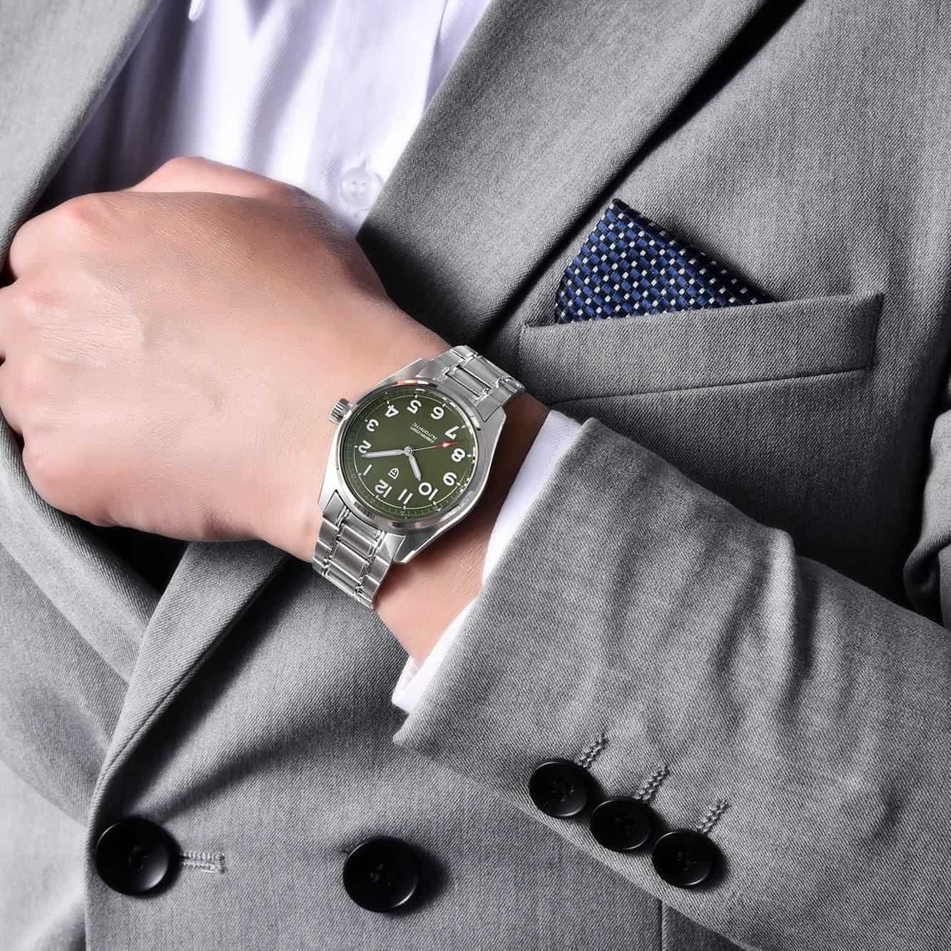 Close-up of a man's wrist wearing a stylish, silver diabetic watch with a black dial and easy-to-read numbers, perfect for diabetic care and health monitoring.