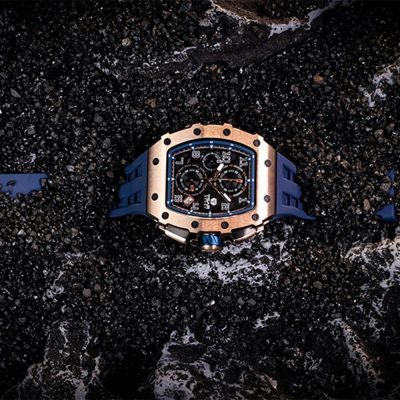 High-end men's chronograph watch with blue rubber strap, black dial, and rose gold case. Perfect for elegant daily wear and special occasions.