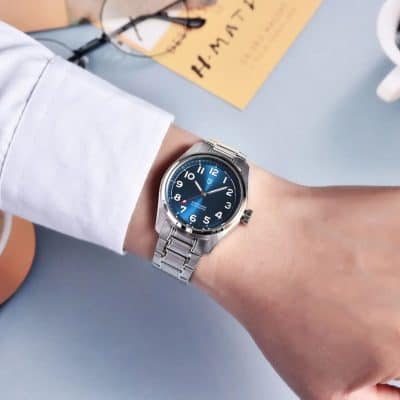 A stylish men's stainless steel wristwatch with a blue dial, chronograph functions, and a sleek metal band, ideal for fashion-conscious individuals.