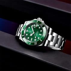 Elegant green dial wristwatch showcasing classic design with date magnifier and water resistance.