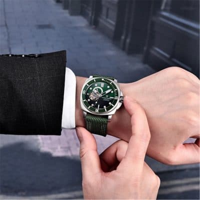 Elegant men’s wristwatch with green dial and strap, showcasing high-end design and craftsmanship for luxury accessories.