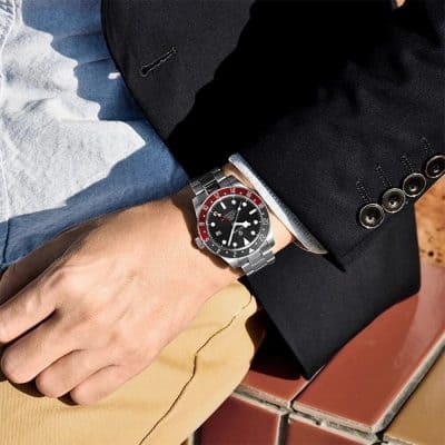 Men's luxury wristwatch featuring stainless steel band, black dial, and red accents, perfect for stylish occasions and everyday wear.