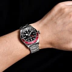 Luxury men's wristwatch with GMT function and stainless steel band.