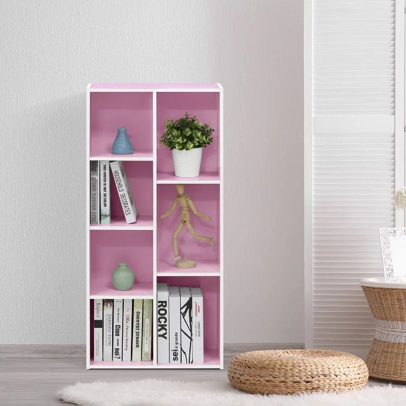 High-quality pink shelf with various decorative items, including vases, a potted plant, and a wooden mannequin, perfect for stylish interior design and home organization.