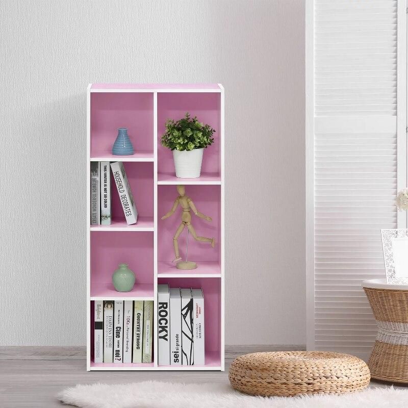A stylish pink bookshelf displaying books, decorative vases, a potted plant, and a wooden mannequin, perfect for modern interior decor and home organization.