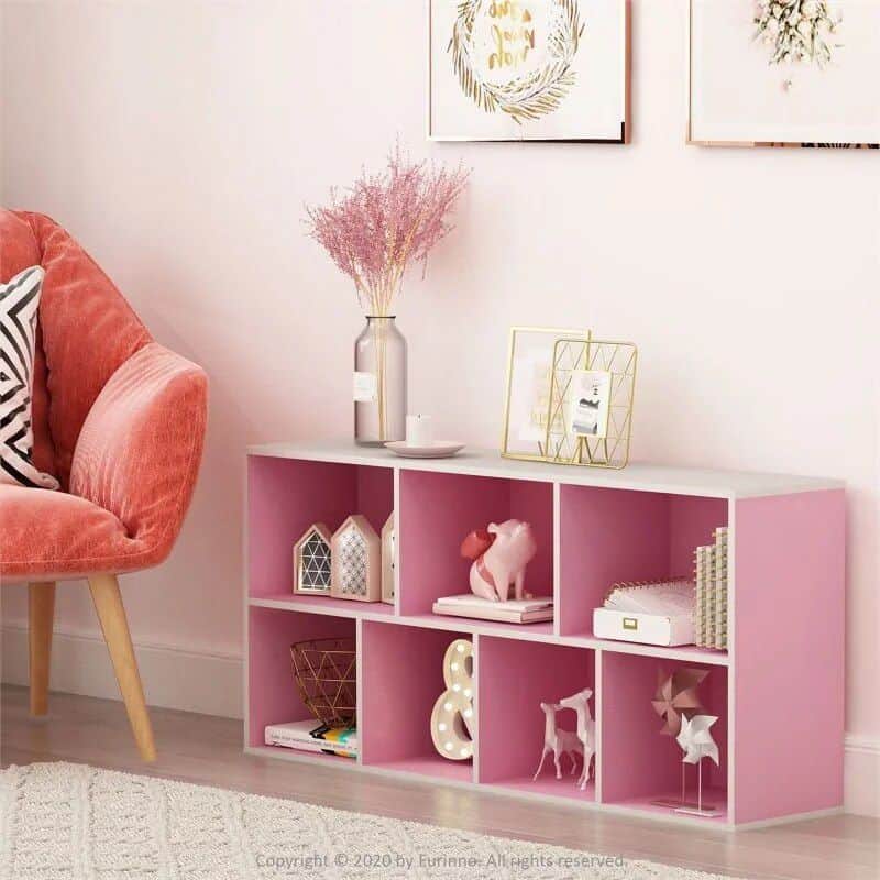 Pink storage shelf with cubbies, perfect for home decor, books, and accessories, adding a stylish touch to living rooms or bedrooms.